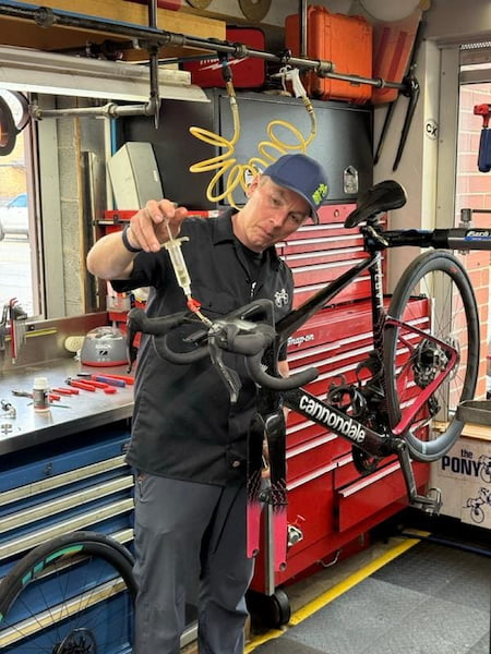 Bike mechanic fixing bike handlebars