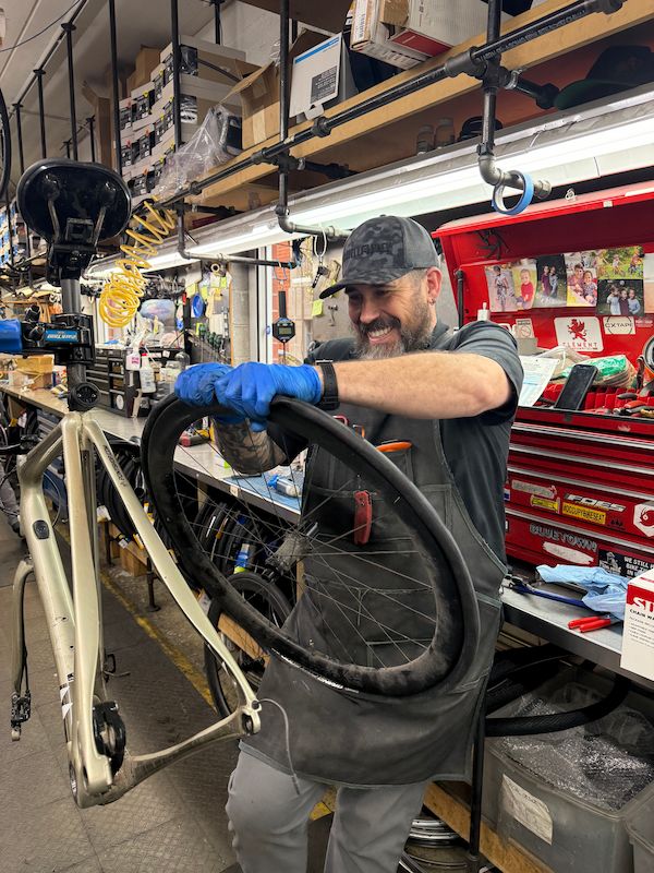Pony Shop Mechanic changing the back tire of a bicycle